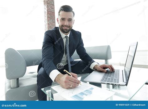 Businessman Working With Business Graphics On A Laptop Computer Stock