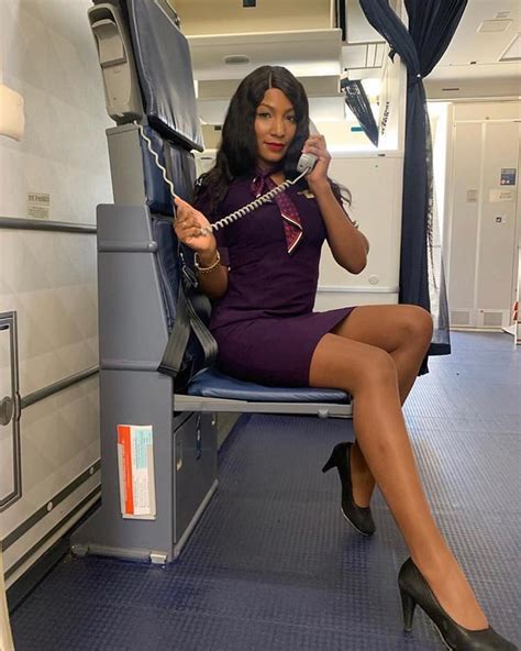 image may contain 1 person sitting and indoor sexy flight attendant flight attendant