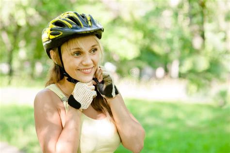 Woman Putting Biking Helmet On Outside During Bicycle Ride Stock Photo Image Of Happy Park
