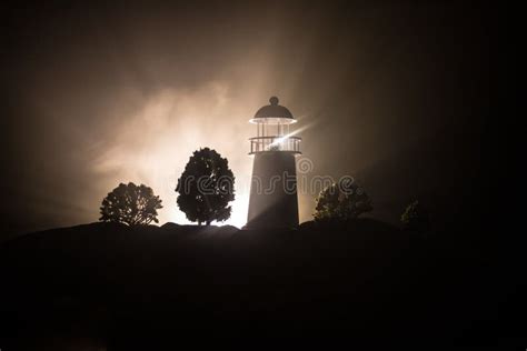Lighthouse With Light Beam At Night With Fog Old Lighthouse Standing
