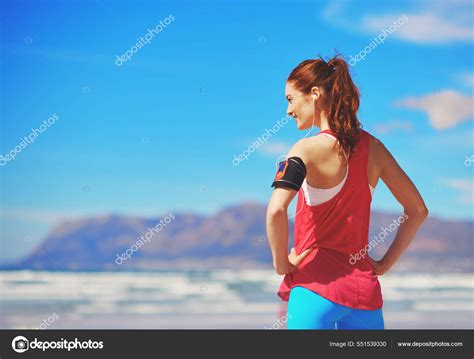 She Loves Working Out On The Beach Rearview Shot Of A Babe Woman Standing With Her Hands On