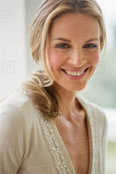 Mature Blonde Woman Looking At Camera Smiling Portrait Stock Photo
