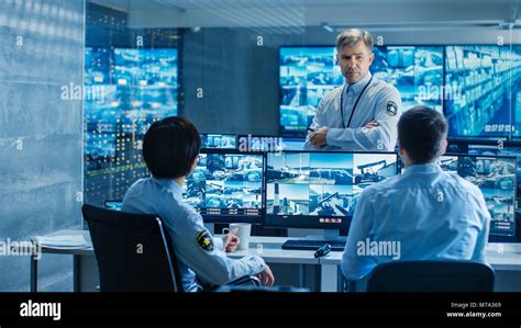 In The Security Control Room Chief Surveillance Officer Holds A