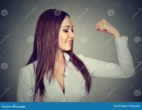 Young Happy Woman Flexing Muscles Showing Her Strength Stock Photo