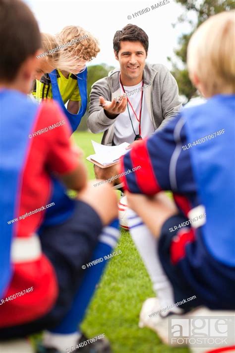 Coach Talking To Childrens Soccer Team Stock Photo Picture And
