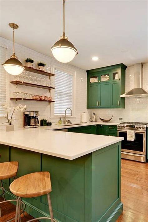 For more on kitchen renovation, visit. White subway tile backsplash, brass accents, and emerald painted cabinets | Kitchen Ideas ...