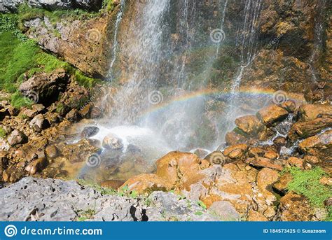 Waterfall With Small Rainbow And Brown Rocks Austrian Alps Stock Image