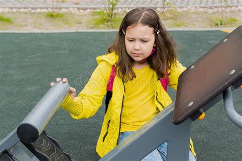 9 Year Old Girl Schoolgirl Is Engaged In Fitness On The Outdoor Simulator Stock Image Image Of