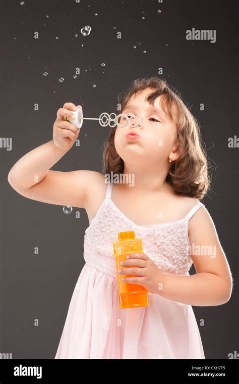 Little Girl Blowing Soap Bubbles Stock Photo Alamy