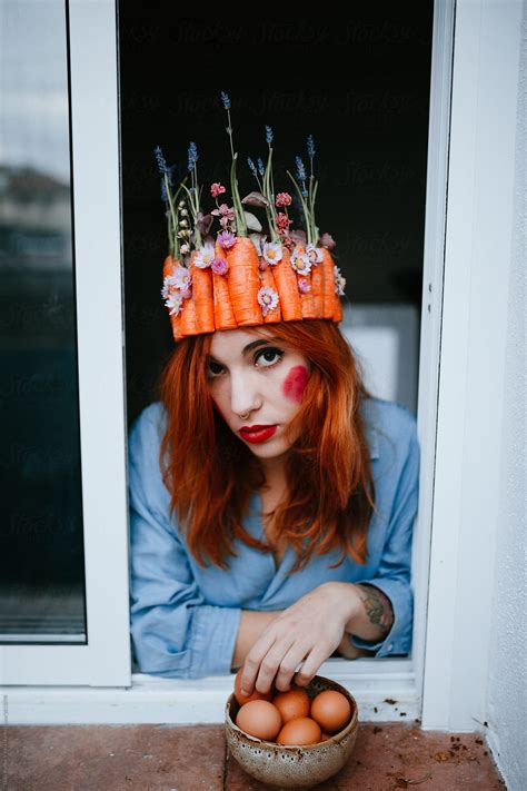 Portrait Of A Redhead Woman Wearing A Carrot Crown At The Window By