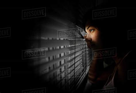 Girl Peeking Out Of Window Stock Photo Dissolve