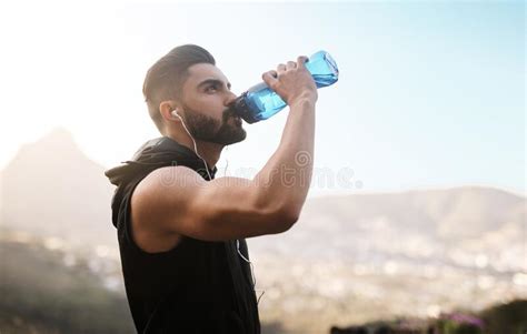 Cooling Off After An Intense Workout A Sporty Young Man Drinking Water