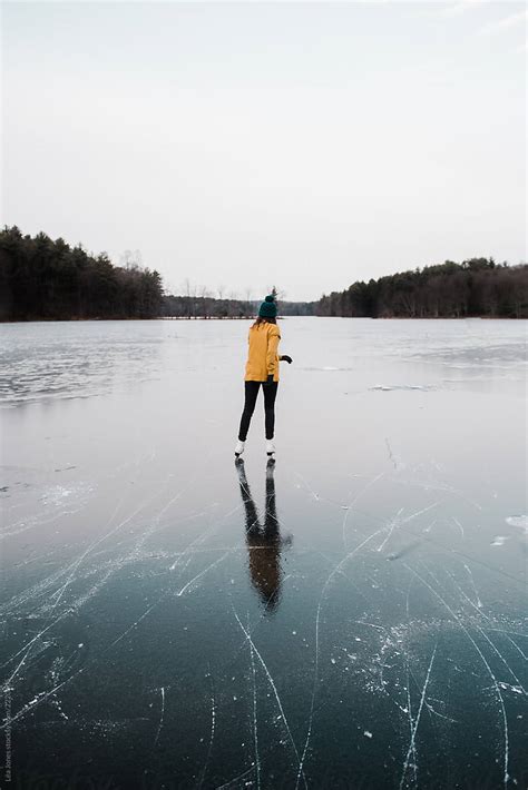 Back Teenage Girl Skating On A Frozen Lake By Léa Jones