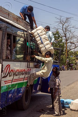 Passenger Loading Luggage On Indian Bus Pushing Large Bundle Over The