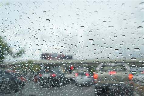 Road View Through Car Window With Rain Drops Driving In Rain Stock