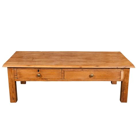 This coffee table is finely constructed from quality mango wood and supported by splayed metal legs. English Pine Coffee Table For Sale at 1stdibs