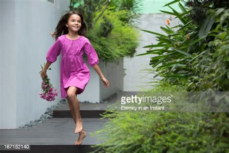 Young Girl Skipping Whilst Holding Flowers Photo Getty Images