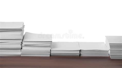 Stacks Of Paper Sheets On Wooden Table Against White Background Stock