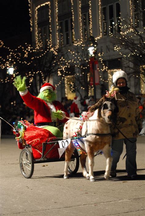 Two People Are Riding In A Horse Drawn Carriage With Grinen On The Side