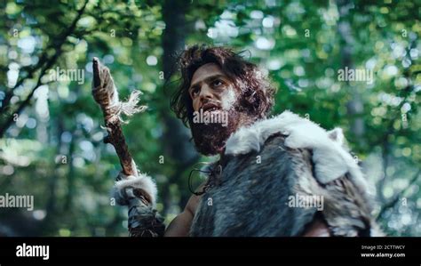 Primeval Caveman Wearing Animal Skin Holds Stone Tipped Spear Looks