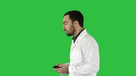 Doctor Talking On Mobile Phone On A Gree Stock Video Pond