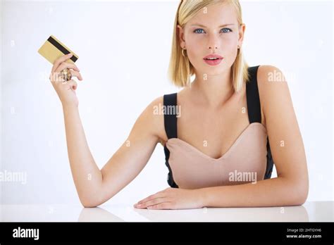 Shes A Big Spender Gorgeous Young Woman Sitting And Holding A Credit Card Portrait Stock
