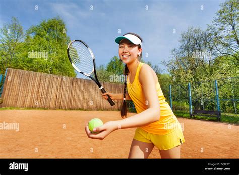 Smiling Female Tennis Player Serving Outdoor Stock Photo Alamy