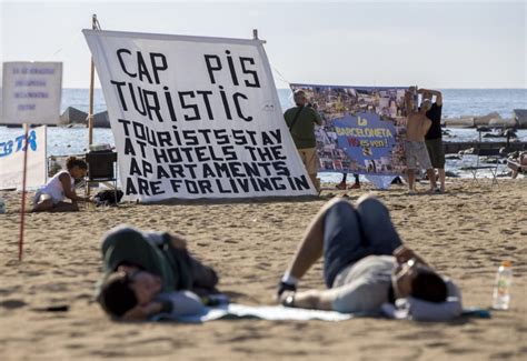 Dozens Of Locals Storm Barcelona Beach In Protest Against Rowdy