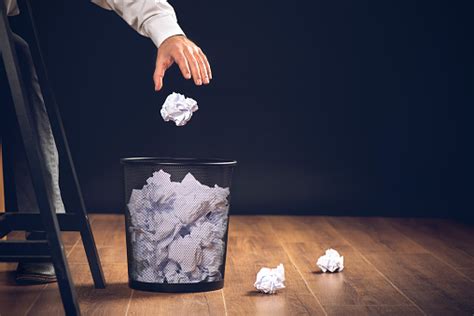 man throwing away papers into trash bin inspiration creativity and idea concept for business