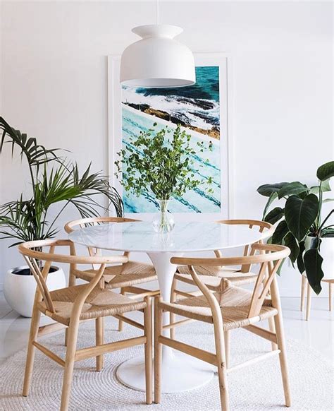It is the perfect choice if you're looking for a centrepiece table for a home with a distinct modern or. Beachy dining room decor with tulip table and wishbone ...