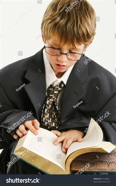 Adorable 7 Year Old Boy In Baggy Suit And Glasses Reading Book Stock