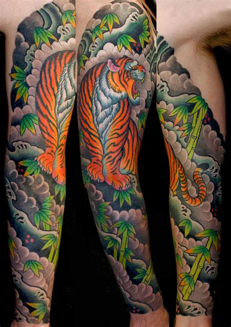 A half sleeve roaring tiger, the design of this tattoo allows the gaps to be filled in by the wearer's skin in unique and artful ways. Animals Japanese Sleeve Tiger Tattoo - Slave to the Needle