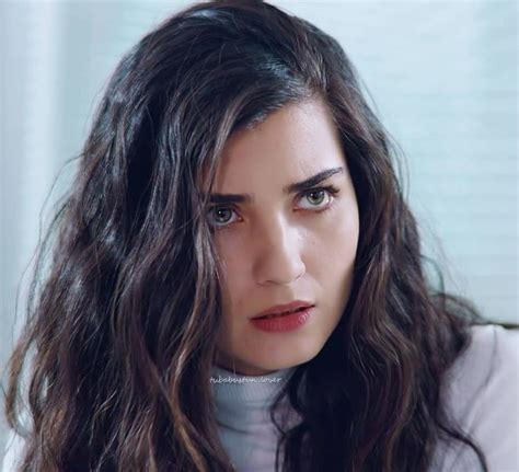 A Close Up Of A Person With Long Hair Wearing A White Shirt And Looking