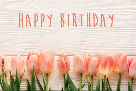 Happy Birthday Text Sign On Pink Tulips On White Rustic Wooden