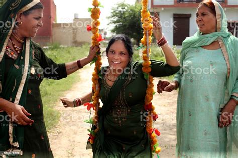 Three Mature Indian Women Swinging On Swing During Haryali Teej