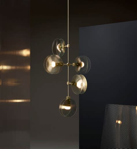 An Elegant Chandelier With Five Glass Balls Hanging From It S Brass Finish