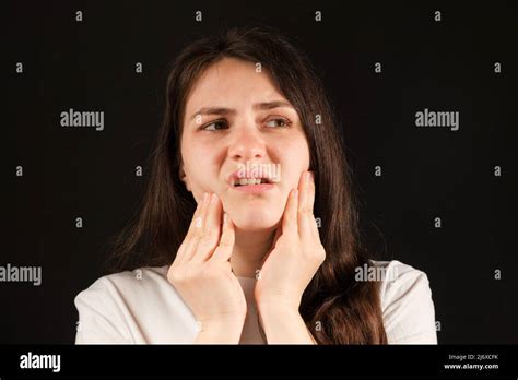 A Woman Holds Her Hands To A Sore Temporomandibular Joint Dysfunction