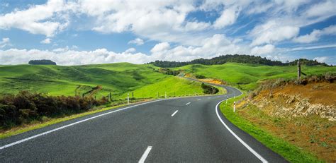 New Zealand Winding Road Through Green Hills Find Away Photography