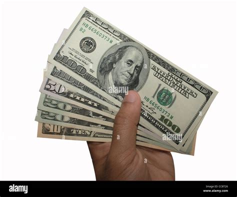 A Person Holding A Stack Of Us Currency Dollars In His Hand Stock