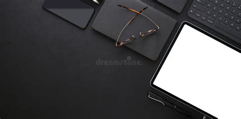 Top View Of Dark Trendy Workplace With Blank Screen Tablet Stock Photo
