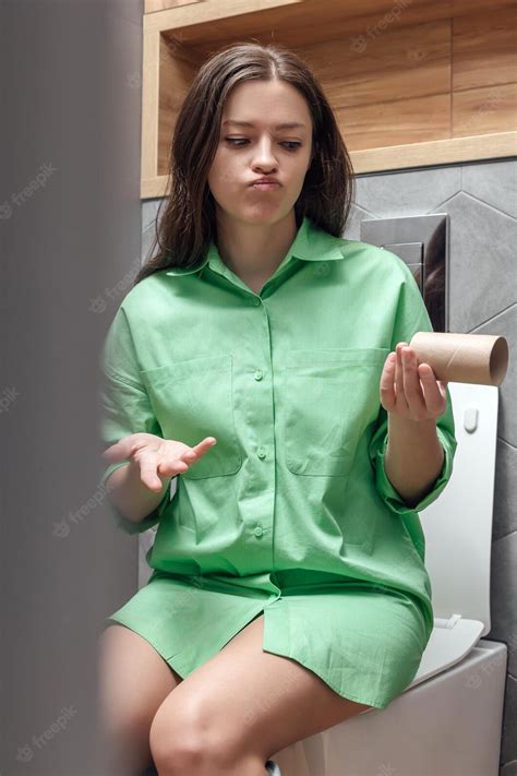 Premium Photo Young Woman Sitting On The Toilet Has Run Out Of Toilet