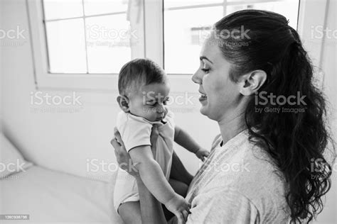 Young Mom Having Fun With Her Son In Bed At Home Focus On Mother Face