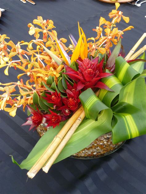 Centerpiece With Yeollow Spotted Mokara Orchids Red Bromeliad Bird Of Paradise Variegated Ti