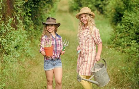 Agriculture Concept Girls In Hats Planting Plants Sisters Helping At