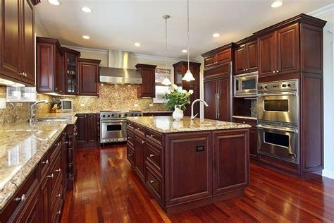 Kitchen In Luxury Home With Dark Cherry Wood Cabinetry Wood Flooring