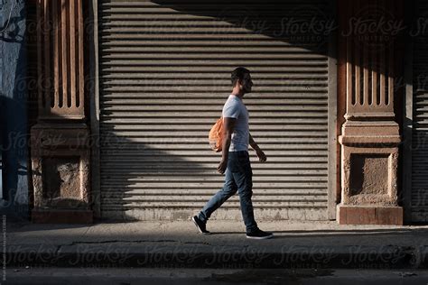 Young Man Walking Down The Street By Stocksy Contributor B Krokodil