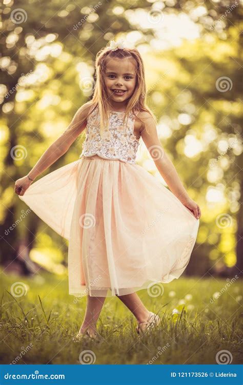 Beautiful Little Girl In Nature Poses To Camera Stock Photo Image Of