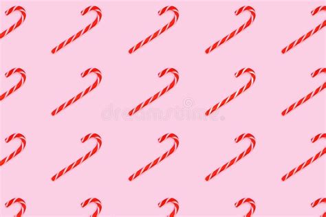 Pattern Made From Christmas Candy Canes Isolated On Pink Stock Photo