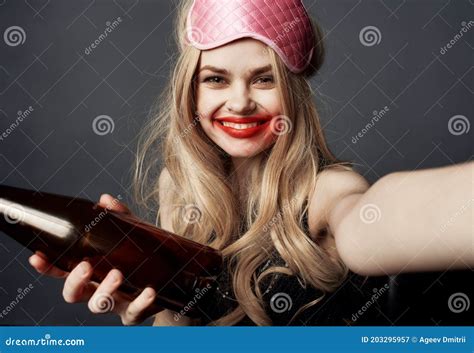 Drunk Blonde Girl With A Bottle Of Beer Gestures With Her Hands And A Bright Makeup Addiction