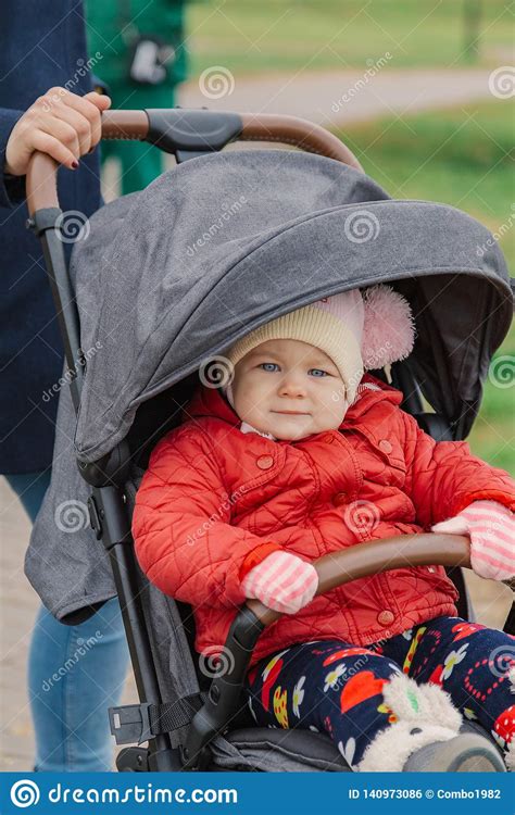 The Little Baby Is Sitting In The Pram Stock Photo Image Of Design